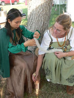 Bridget loves to teach! Here she teaches a young lady how to spin with a drops spindle. 2010
