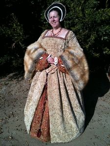 Picture Title Her Ladyship in a dress, made in likeness of Katherine Parr, Henry VIII's last wife. The suit includes beaded gown, Henrecian kirtle, French hood, jewelry, and shoes.