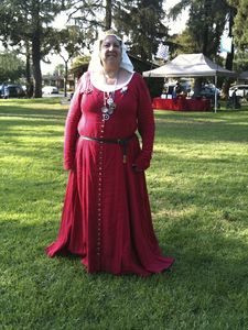 Baroness Ceara 14th century cotehardie of red linen with working buttonholes down the front and an the sleeves, worn over a white linen chemise.