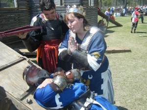 Queen Kolfinna prays for a fallen Prince Edward, who died gloriously while storming the castle.