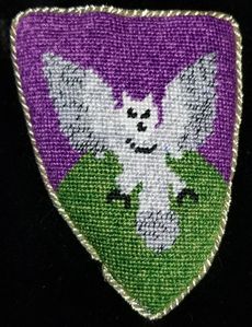 Mora de Buchanan Per chevron purpure and vert, an owl rising guardant wings displayed argent. Her Grace was admitted to the Order of the Pelican by Their Majesties Patrick I and Kara I on March 13, AS XLIV (2010).