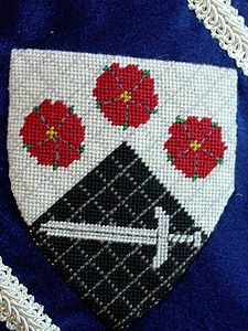 Martin FitzJames Per chevron argent and sable, three roses in chevron proper and a sword fesswise argent (registered 01/08). Maker: Louise of Woodsholme