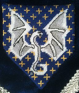 Richard of Castle North Azure, mullety of four points Or, a pithon displayed, head to sinister argent. (registered 10/1990). Maker: Louise of Woodsholme.