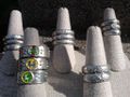 A variety of pewter rings, some enamel-painted