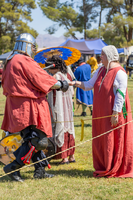 Beorn showing honor to his consort, THL Avicia, at Caid's Fall Crown Tournament, 2023. Photo by Duchess Tsyra tsheere Nanoup