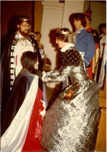 Amsha investing Neptha of Thebes with the Queen's cloak as newly-crowned Martin the Temperate looks on at Coronation on 05/31/1980