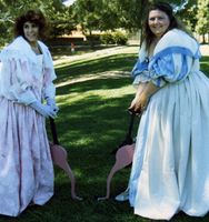 Cavalier ladies Kathleen Lennox and Colleen of Dael playing croquet with pink flamingoes.