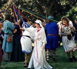 Dancers around the maypole, including Angela of Rosebury and Eowyn Amberdrake