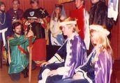 Caid's first monarchs Armand and Diana. Background (L-R): Sir Charles of Dublin, Master Alewaulfe the Red, Baron Conrad von Regensburg, Mistress Mary Taran of Glastonbury, Duke Jason Griffiths of Shadowhyrst kneeling and presenting the Great Sword of State