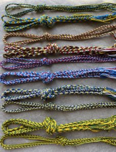 Finger loop braid and whipcord in baronial colors for award cords.