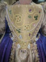 Hand embroidered Elizabethian Stomacher. Gold thread (Plaited Braid and Chain Stitch), Silk threas (Detatched Buttonhole). Spangles, rhinestones, pearls, crystals, and sequins. The design is based on examples from the Elizabethian era. Elements were designed with Duchess Bridget Lucia Mackenzie in mind. There is a hidden Mickey, as well as roses, caterpiller, strawberry and strawberry leaves.