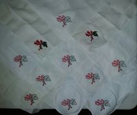 Hand embroidered handkerchiefs. These were given out to the consorts during Crown Tourney. The design is a thistle and oak leaf to represent Sir Adam and myself. It is cotton thread on linen (for easy care). Split stitch.
