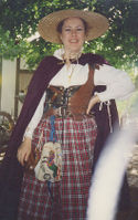 Elizabethan Peasant Garb: I pieced leather patches to make the bodice, used 100% cotton for the chemise as well as the red plaid skirt. I embroidered a Celtic lion on the pouch.