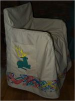 Honour Greenhart chair cover: 100% cotton duck base. The devices were appliqué & put on the pockets of the chairs – one on each side. Because they had a doggie, knotted dogs ran around the hem & were painted with thinned acrylic paint (from Home Depot).