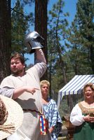 Beorn running a helm auction at Gallavally Anniversary, 2001. Photo by THLBroichan maqq Kynat