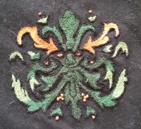 Hand embroidered greenman for THL Adam Makandro. Wool thread on wool. Split stitch - Viking age hood.