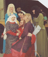 Norman 1160 Tunic: 100% wool plaid, linen wimple and veil, red raw silk chemise. IN photo of Altavia's Baron with the Ladies in Waiting: Clockwise from Duryn the Red, Edith, Gertraud von Wuerzburg, Lynnette de Sandoval del Valle de los Unicornios, Madeleine FitzRobert de la Foret, and ?