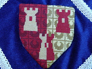 Gareth Nikodemos Somerset Per pale gules and Or, three towers counterchanged (registered 07/99). Maker: Louise of Woodsholme