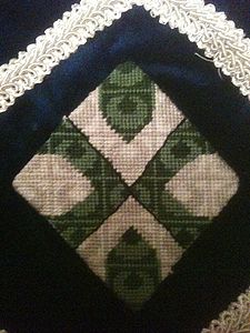 Joan of Crawfordsmuir Per saltire vert and argent, a saltire patty throughout counterchanged. (registered 9/1971). Maker: Louise of Woodsholme.