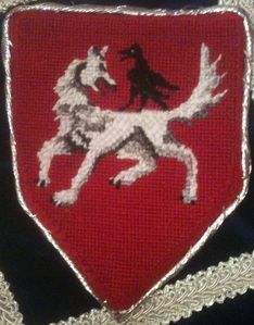 Lizbeth Ravensholm Gules, a wolf passant reguardant argent armed sable, perched on its back a raven croaking proper. (registered January of 1974 (via the West) and reblazoned in June of 2009 (via the West)1). Maker: Lizbeth Ravensholm; Designer: Louise of Woodsholme.