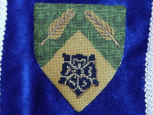 Tetchubah of Greenlake Per chevron vert and Or, two quills in chevron Or and a rose sable (registered 05/86). Maker: Louise of Woodsholme