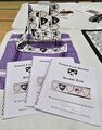 Cross stitched trim display, Arts & Sciences Fair and Pentathlon 2025 team entry for the Dreiburgen Artistic Dragons