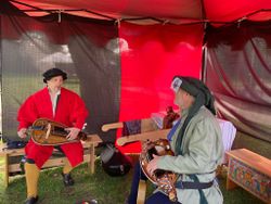 Mons wearing his Tudor coat based on images from “The Embarcation at Dover” playing Hurdy Gurdy with his friend, Montaigne (photo by Ann Hartl)