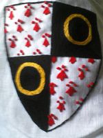 Hand embroidered device to be placed on hoods for Baron/Baroness of Naevehjem. Cotton thread on linen. Split stitch.