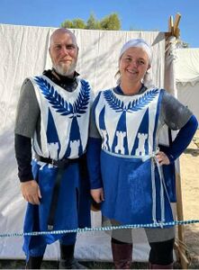 Ramvoldus Kröll and Kungund Benehonig in their baronial fighting tabards. Wool and linen tabards created by Kungund. GWW 2022